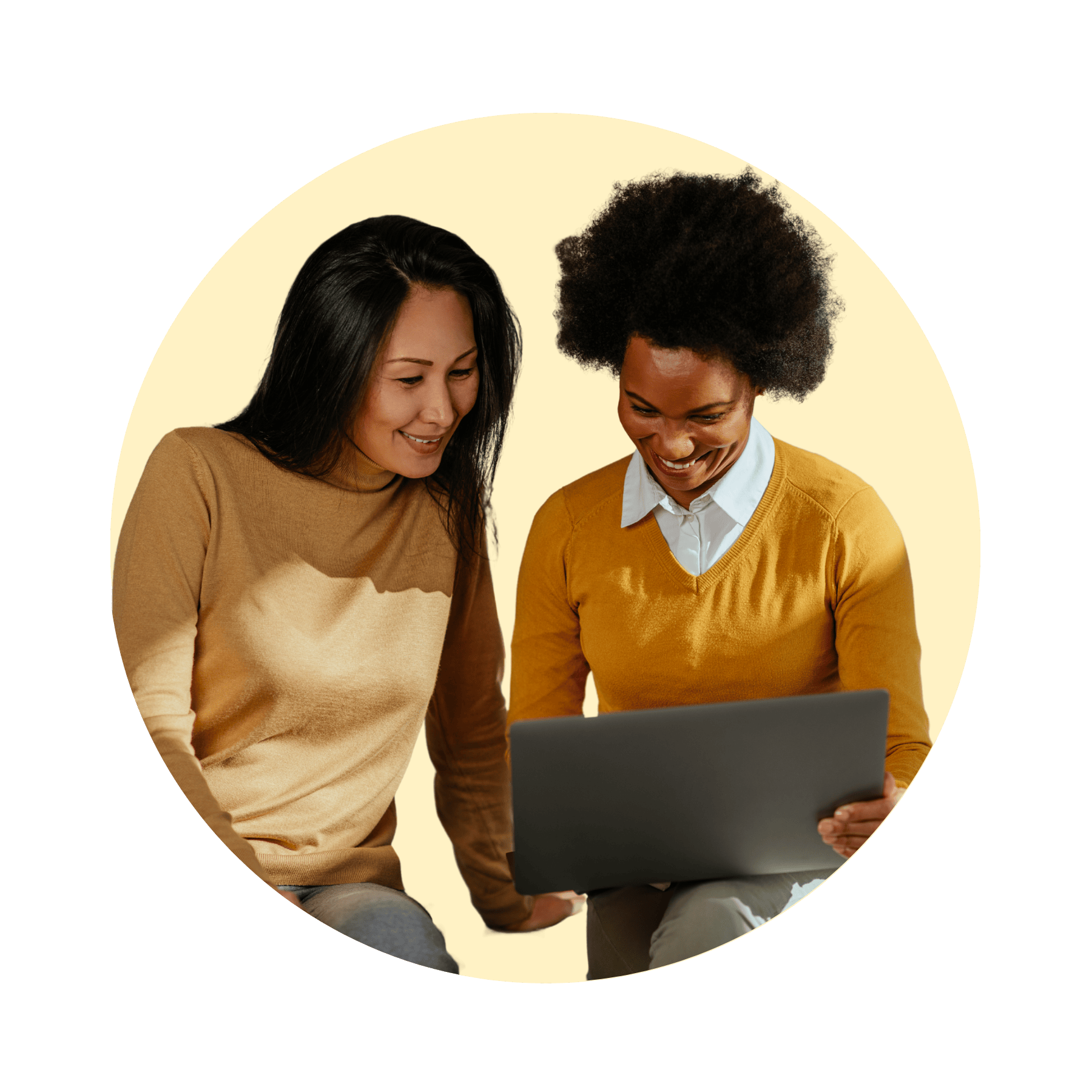 two colleagues looking at laptop smiling